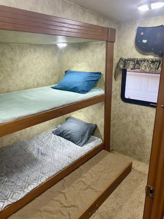 This RV rental features comfortable bunk beds and a pull-out trundle bed, perfect for family travel.. Keystone Cougar 2012