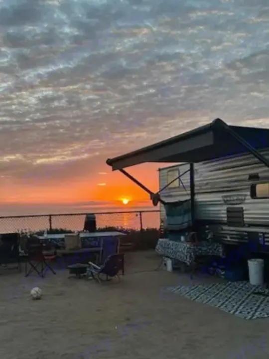 Experience epic RV rental sunsets by the ocean! Cozy setup with extended awning, chairs, and stunning views.. Forest River Salem Cruise Lite 2022