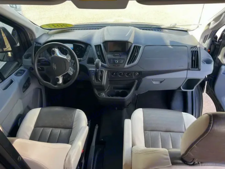 RV rental: Clean, spacious front cabin with a Ford dashboard, steering wheel, and comfortable two-tone seats.. Winnebago Paseo 2017