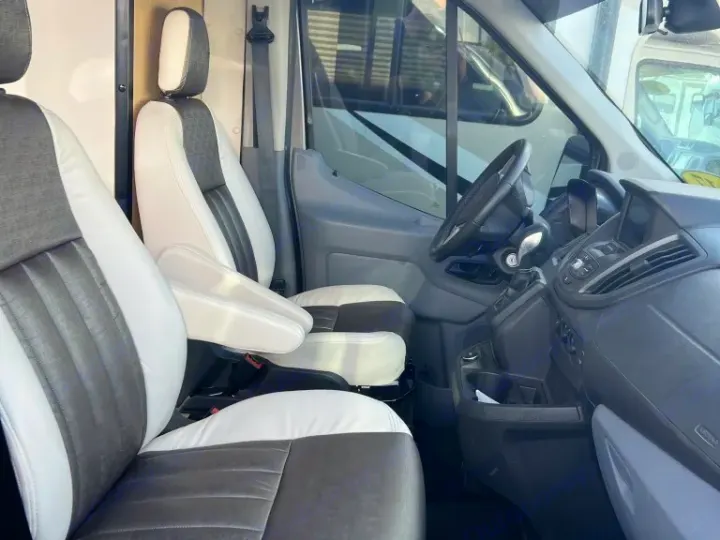 Spacious RV rental interior: two-tone front seats and dashboard, ready for your next adventure.. Winnebago Paseo 2017