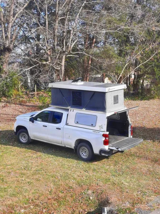 When at rest the pop up camper extends as shown above. The renter is required to ensure that the pop-up top is closed and secured properly with clamped and locked carabiners prior to entering a roadway or driving at roadway speeds with the top deployed.. Chevrolet Silverado 2022