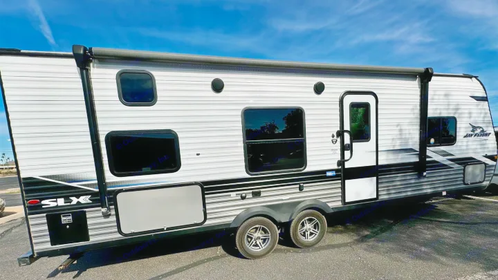 Sleek white & gray Jay Flight SLX travel trailer, perfect for your next RV rental and outdoor adventure.. Jayco Jay Flight SLX 2022
