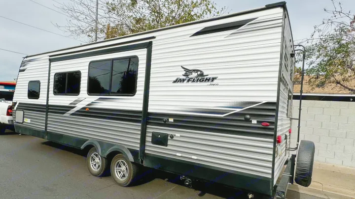 This sleek white, black, and grey Jayco Jay Flight travel trailer is available for RV rental, ideal for road trips.. Jayco Jay Flight SLX Rocky Mountain Edition 2022