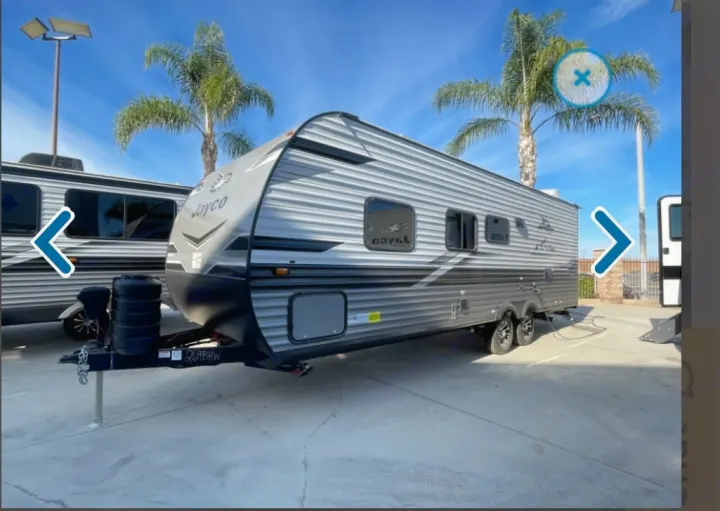 Jayco travel trailer RV rental. This sleek grey RV is parked outdoors on a sunny day, perfect for road trips and family adventures.. Jayco Jay flight 2024