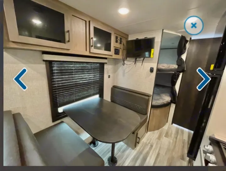 Inside an RV rental: Compact living with a dinette, bunk beds, kitchenette, and overhead cabinets.. Jayco Jay flight 2024