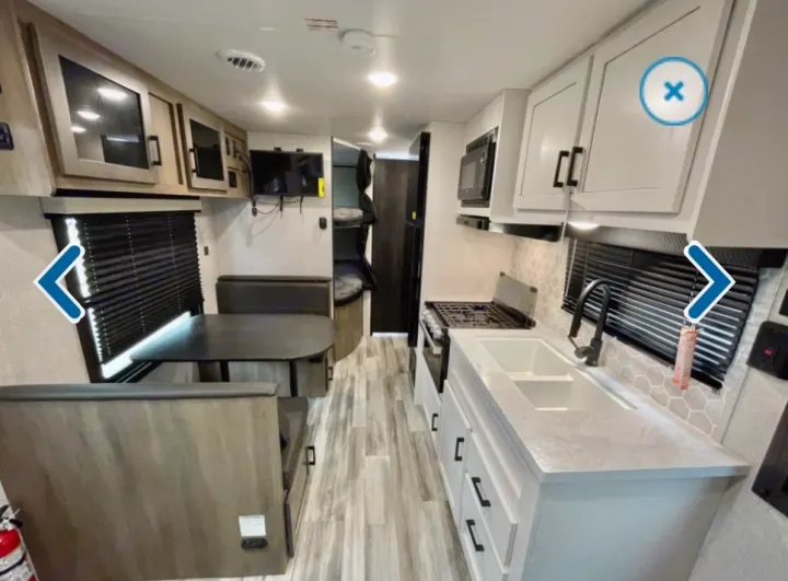 RV rental interior: modern kitchen, dining booth, and bunk beds. Perfect for your next road trip adventure.. Jayco Jay flight 2024