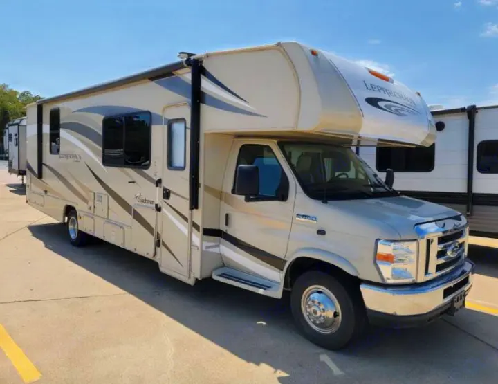 This spacious beige Class C motorhome, a Coachmen Leprechaun, is ideal for an RV rental adventure.. Other Other 2019