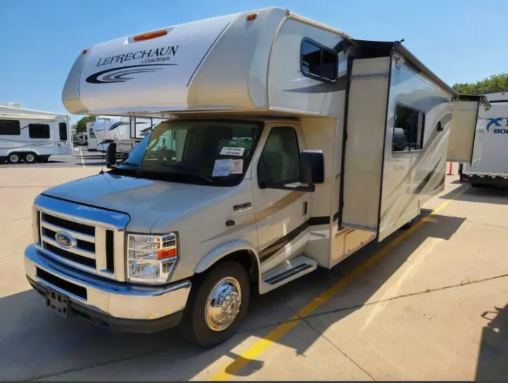 A beige Class C Coachmen Leprechaun RV with extended slide-out and awning, perfect for your next rv rental trip.. Other Other 2019