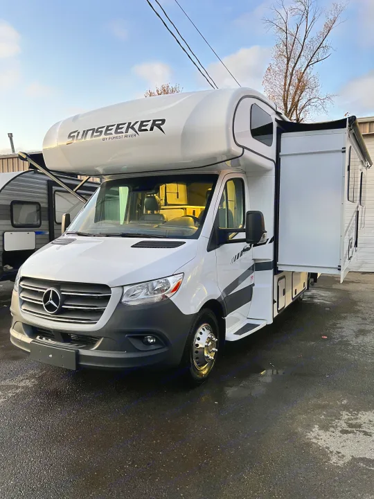 Bright white Sunseeker RV motorhome rental by Forest River, built on a Mercedes-Benz chassis, with its side slide-out extended.. Forest River Sunseeker 2024