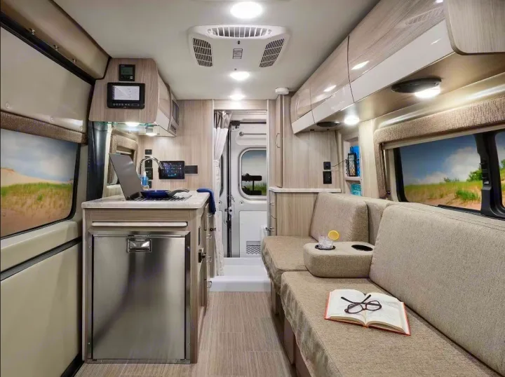 This RV rental offers a compact kitchen, comfy lounge with book/drink, and control panels. Ideal for mobile living.. Thor Scope 2023