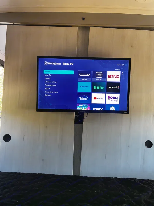 RV rental interior featuring a Westinghouse Roku TV displaying popular streaming apps like Netflix and Hulu, for entertainment on the go.. Heartland RVs North Trail 2023