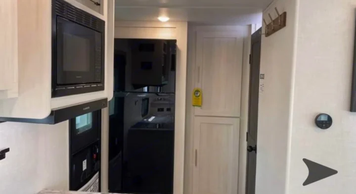 Inside an RV rental: kitchen appliances, cabinetry, and controls. Perfect for road trips!. Forest River Surveyor Legend 202RBLE 2024