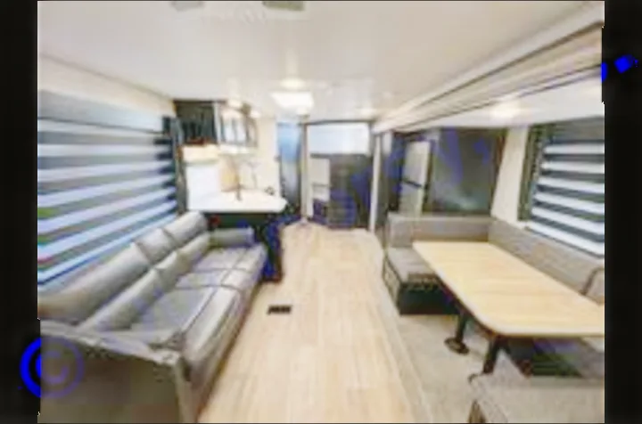 Explore this modern rv rental's interior: comfy sofa, dining booth, and full kitchen. Ideal for road trips and vacations.. Forest River Cherokee 2022
