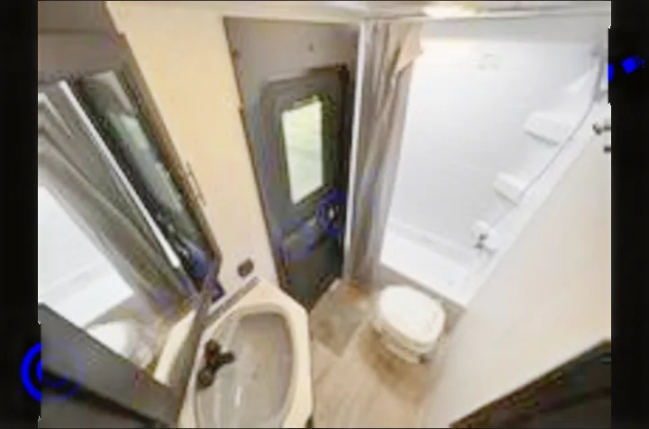 This RV rental bathroom offers a clean shower, toilet, and sink in a compact space, ideal for travel comfort.. Forest River Cherokee 2022