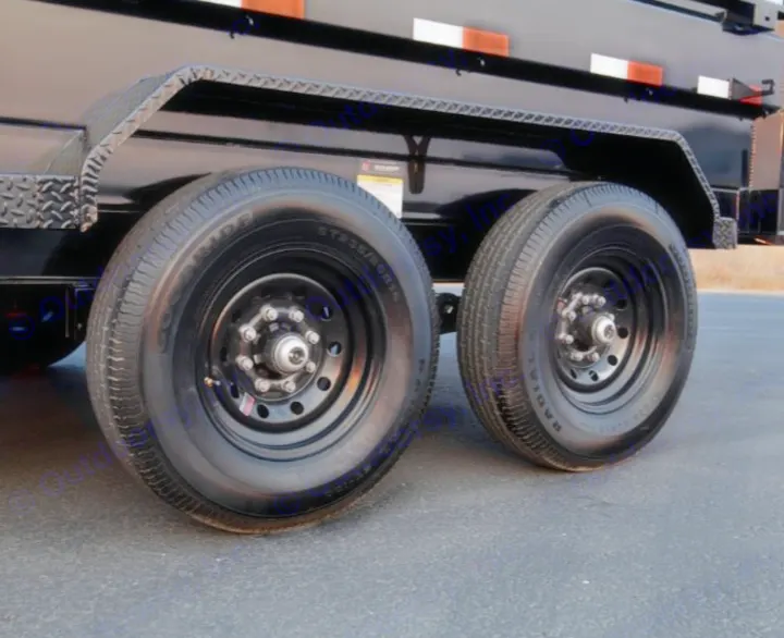 Heavy-duty dual black trailer wheels & tires ensure a smooth rv rental journey. Built for reliability.. Iron Bull 7x14 Dump Trailer 2022