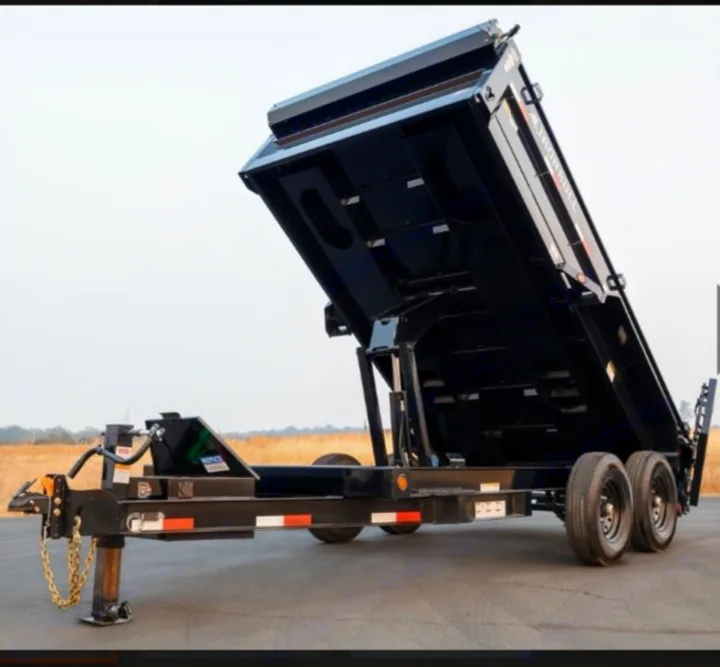 A black dump trailer with its bed raised, showing dual axles. Useful for hauling materials, sometimes offered by equipment or RV rental services.. Iron Bull 7x14 Dump Trailer 2022