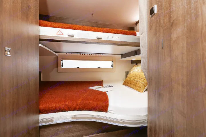 Inside this RV rental: a cozy, well-lit sleeping area featuring lower and upper bunk beds, perfect for trips.. Benimar Sport 340 UP 2024