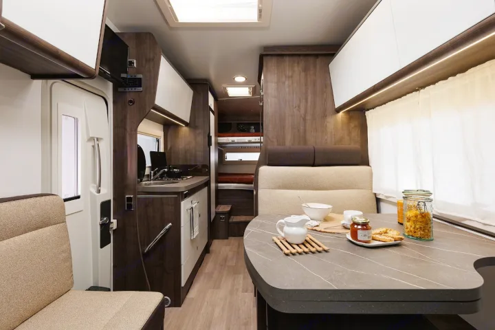 Experience compact comfort in this RV rental! Interior features a dining area with breakfast, kitchenette, and bunk beds.. Benimar Sport 340 UP 2024