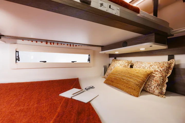 Experience comfort in this RV rental! Features a bed, reading lights, window, and a clever pull-down bunk.. Benimar Sport 340 UP 2024