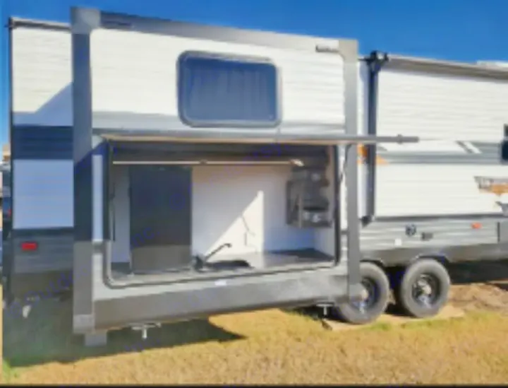 Travel trailer RV rental with large side panel open, revealing an outdoor kitchen area & storage. Ready for adventure.. Forest River Wildwood 2022
