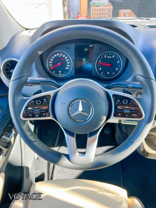 Modern Mercedes-Benz car interior, showing steering wheel and dashboard details. Ideal for an RV rental trip or long journey.. Mercedes-Benz Sprinter 419 LWB High Roof 2024