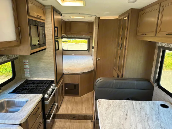 Spacious RV rental interior with a full kitchen, comfortable bedroom, and dinette area, perfect for your next road trip.. Coleman 22EQ 2022