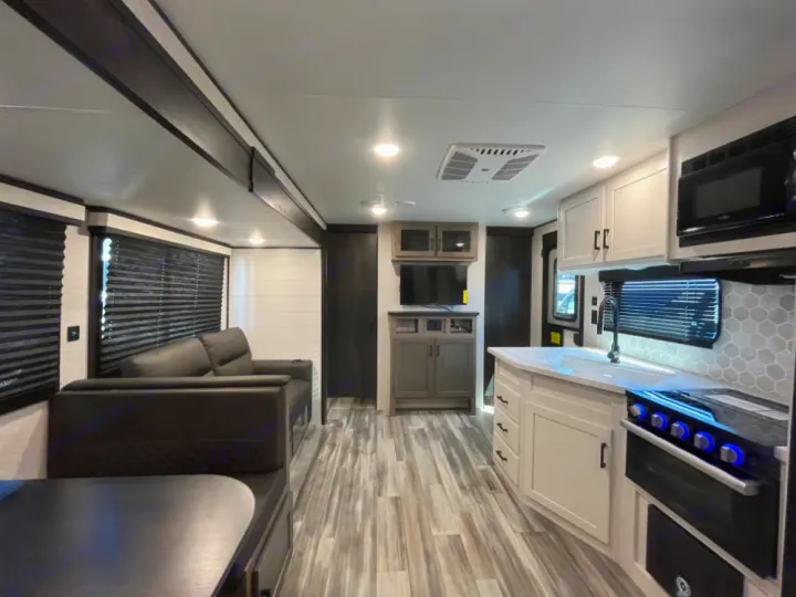 Modern RV rental interior showcasing a compact kitchen, sofa, and comfortable living space.. Jayco Jay Flight 2024
