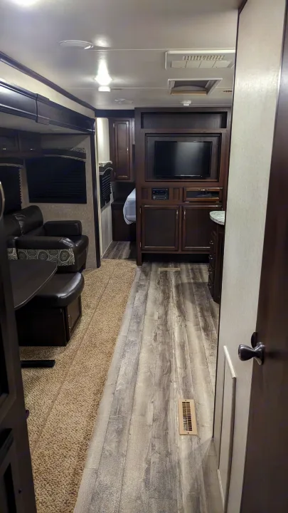 Modern RV rental interior with living area, sofa, dining table, entertainment center, and kitchen.. Jayco Jay Flight 2018
