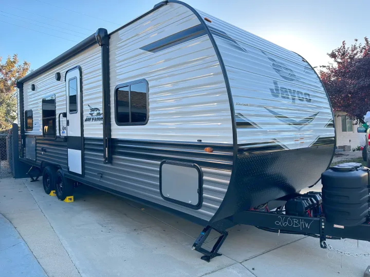 A large, white and gray Jayco travel trailer RV (model 260BHW), ideal for an RV rental, parked on concrete outdoors.. Other Other 2024