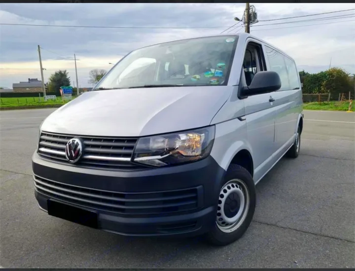 Silver Volkswagen van (T6 model), often chosen for rv rental and travel, parked on asphalt outdoors.. volkswagen T6 MINIBUS 2017