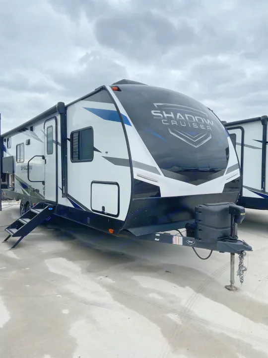 A modern white, black, and blue Shadow Cruiser travel trailer RV, perfect for your next rv rental adventure.. Cruiser RV Shadow Cruiser 2022