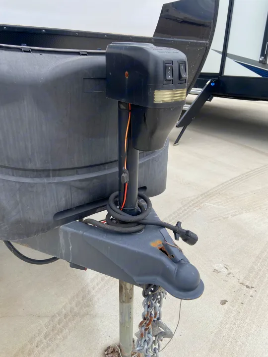 Close-up of an RV rental trailer's front. Features an electric jack, propane tank cover, and hitch for simple setup.. Cruiser RV Shadow Cruiser 2022