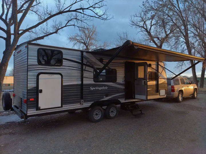 A Springdale travel trailer RV rental parked with awning extended, ready for outdoor adventures.. Keystone RV Springdale Eco-Lite 2018