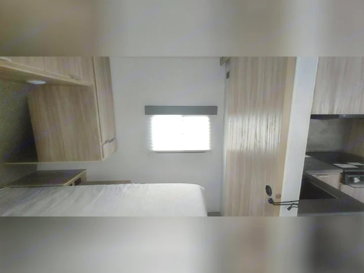 This RV rental offers a compact interior with a bed, window, and kitchen area. Ready for your adventure!. Winnebago 2301BHS 2022