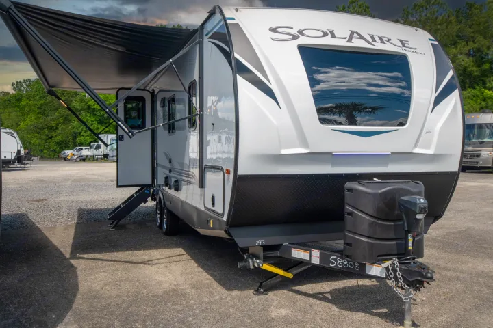 Explore with this Solaire travel trailer RV rental, featuring an extended awning and ready for your next adventure.. Palomino Solaire Ultra Lite 2023