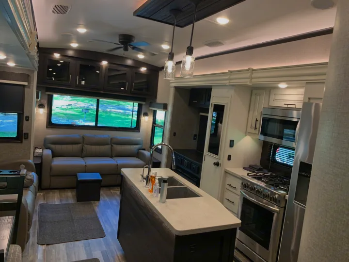 Spacious, modern RV rental interior with a full kitchen, living area, and comfortable seating.. Jayco North Point 2021