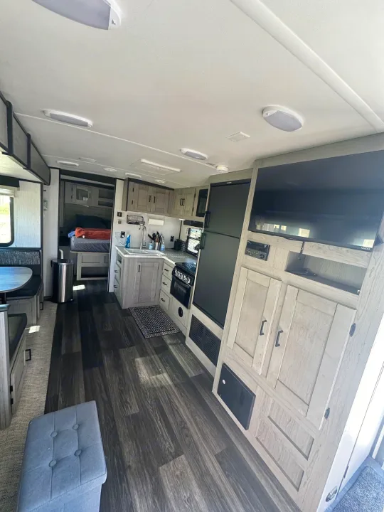 Bright rv rental interior featuring a full kitchen, dinette, entertainment, and cozy bedroom.. Heartland RVs Mallard 2021