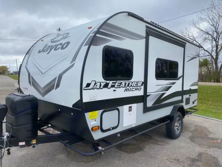 A modern light gray and black Jayco Jay Feather Micro travel trailer is ready for your next RV rental adventure.. Jayco 166 FBS 2022