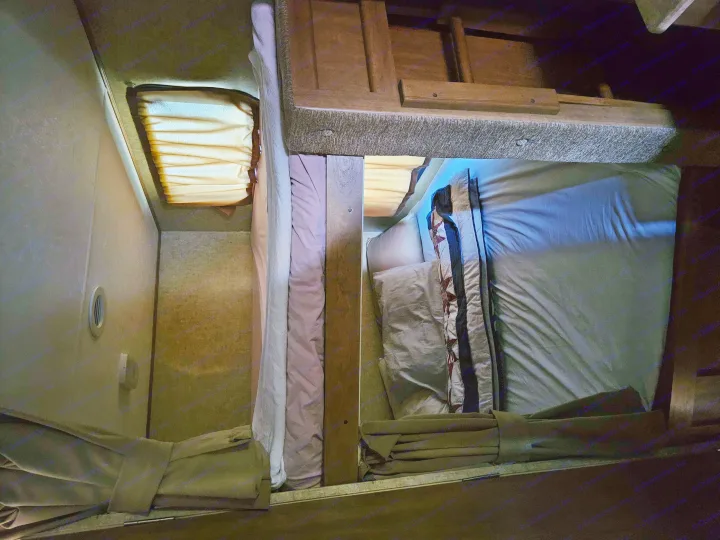 RV rental interior with stacked bunk beds. Note the efficient design & blue accent light, creating a cozy sleeping space.. Coachmen Apex 50th Anniversary 2015