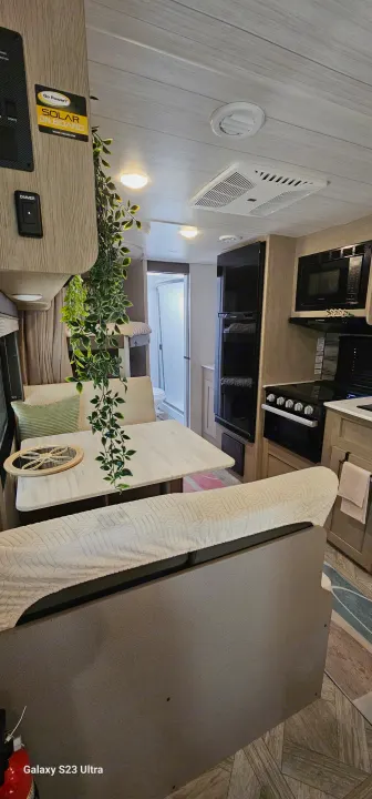 Modern rv rental interior with kitchen, dining, bunks, and bathroom for comfortable adventures.. Forest River Wildwood X-Lite Platinum 2024