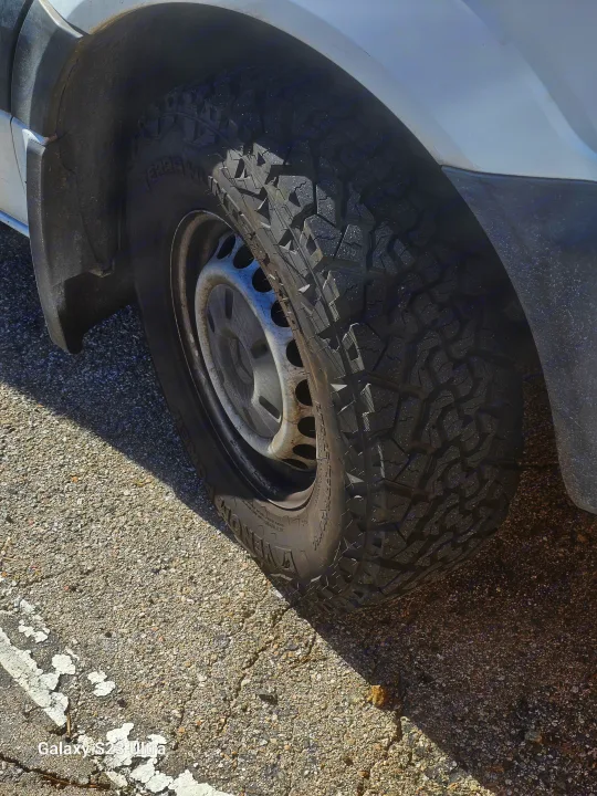 Close-up of a sturdy all-terrain tire and wheel on an RV rental, ready for adventure.. Mercedes Benz Sprinter 2500 2014