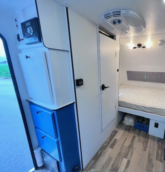 RV rental interior showcasing a bedroom, efficient storage, and entertainment system. Ready for your trip!. Winnie Drop Winnie Drop Trailer 2017
