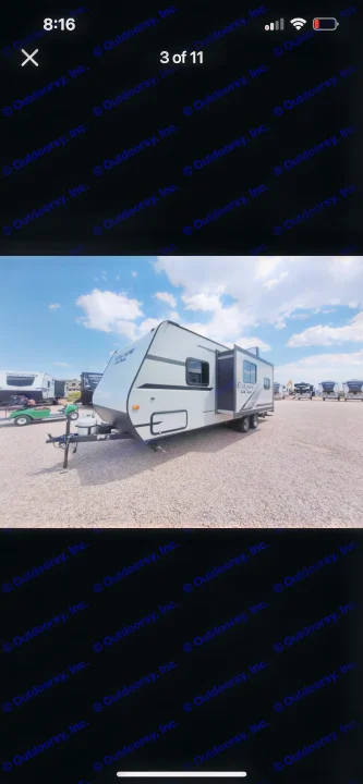 This white "Escape" travel trailer, perfect for your next RV rental, is parked on a spacious gravel lot.. KZ Escape 2019