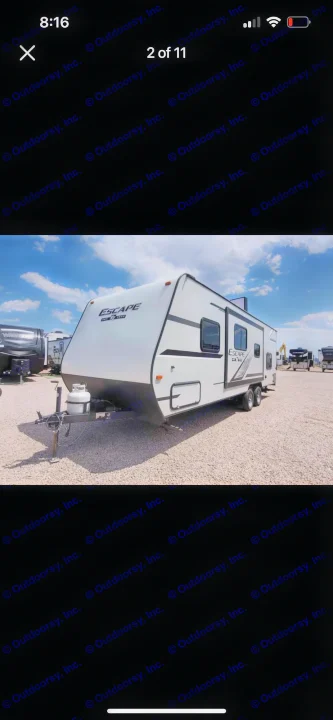 White Escape travel trailer parked on a gravel lot, ready for RV rental.. KZ Escape 2019