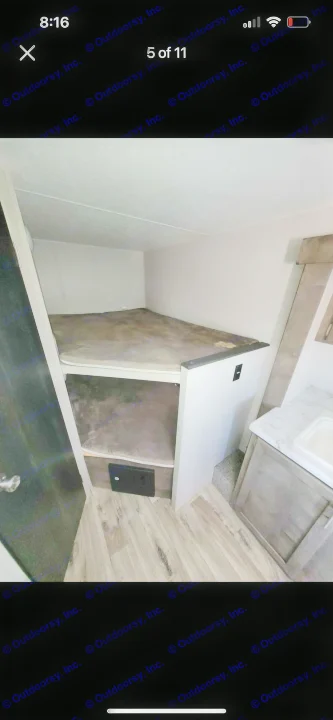 RV rental interior: a cozy set of bunk beds on the left, with a small kitchen counter and sink visible on the right.. KZ Escape 2019