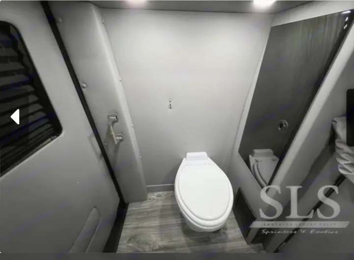 Sleek and compact RV rental bathroom featuring a white toilet, essential for comfortable travel.. Midwest Automotive Designs Day Cruiser 2024