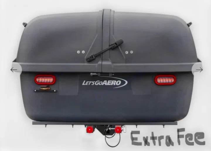 Rear view of a dark gray LET'S GO AERO cargo carrier, an essential RV rental accessory for extra gear.. Midwest Automotive Designs Day Cruiser 2024
