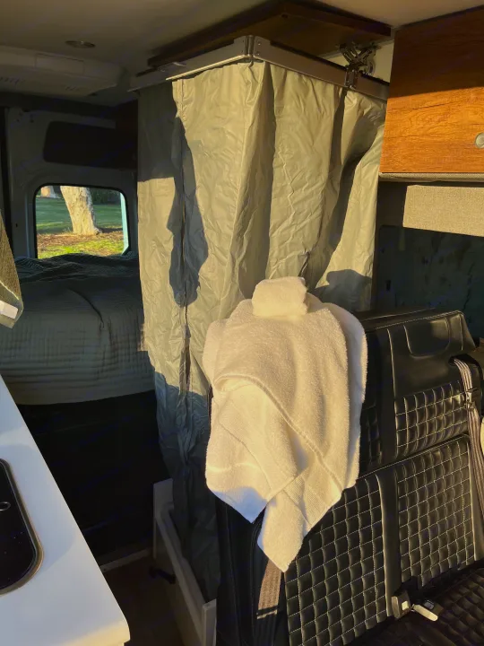 This rv rental features a well-designed camper van interior with a cozy bed, shower area, and comfortable seating.. Storyteller Overland Storyteller Overland Class B 2020
