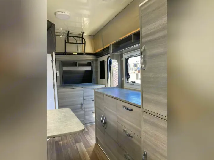RV rental: Clean interior with sleek kitchenette, ample storage cabinets, and a handy fold-down table.. OBI OBI Popup Trailer 2022