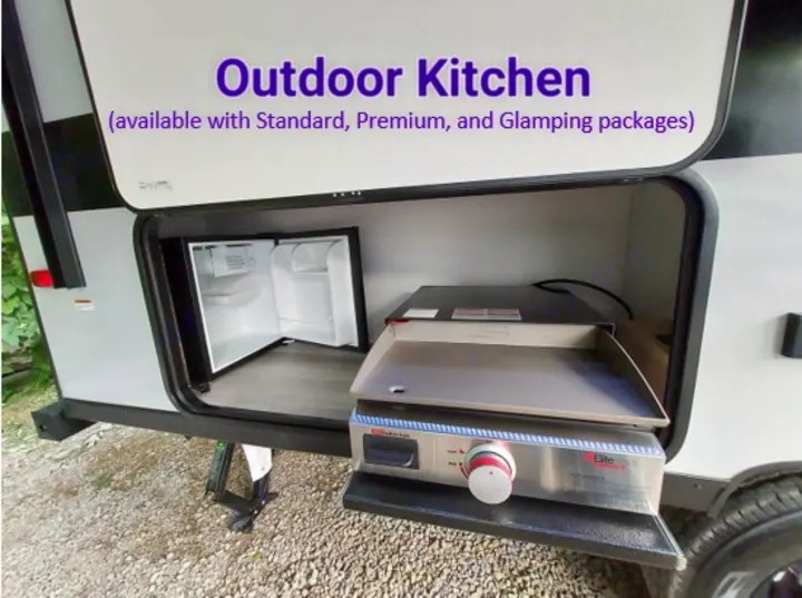 This RV rental offers an outdoor kitchen with a mini-fridge and griddle, perfect for easy outdoor cooking.. Forest River Salem FSX Platinum 2023